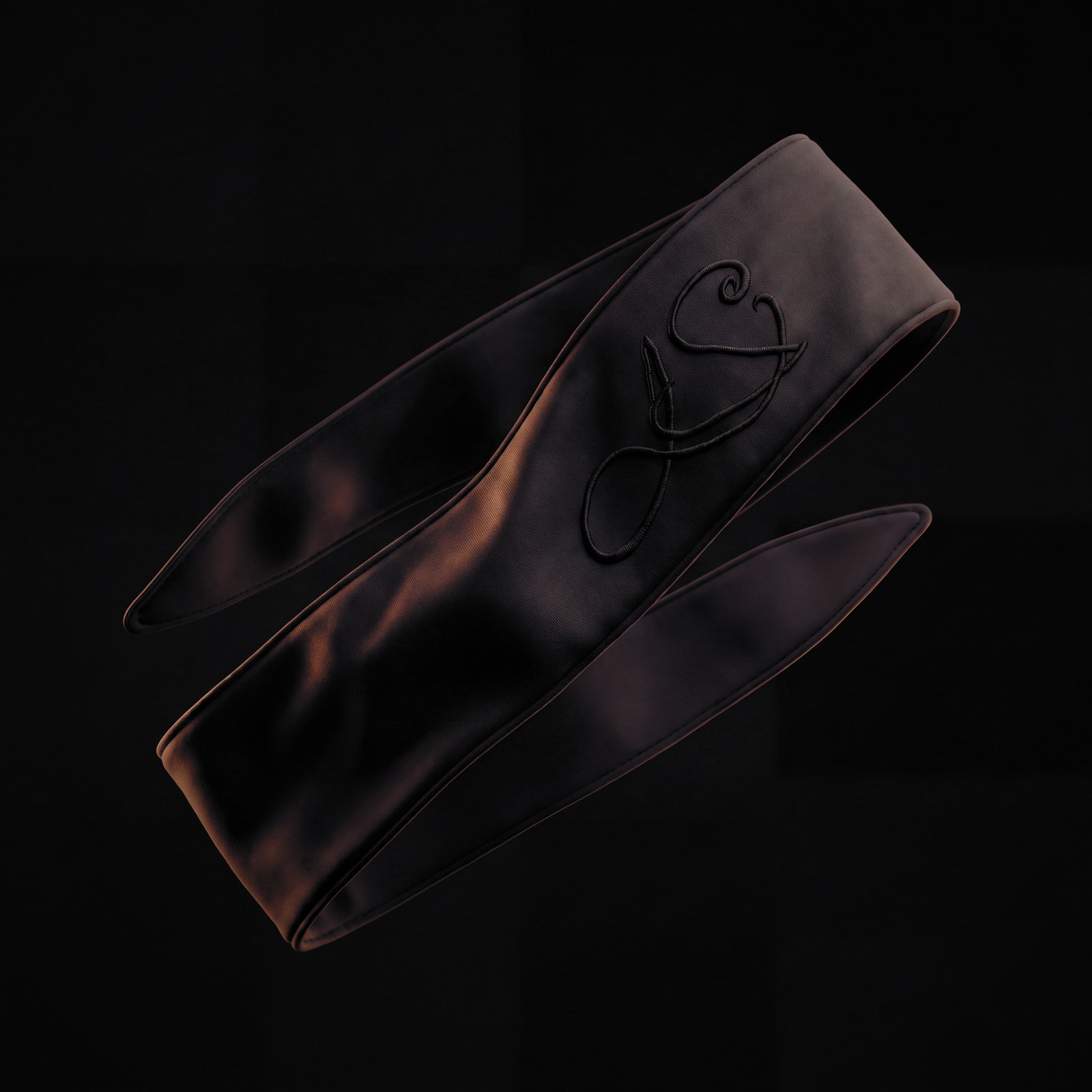 The LS headband suspended in the dark, monogram catching a low warm light